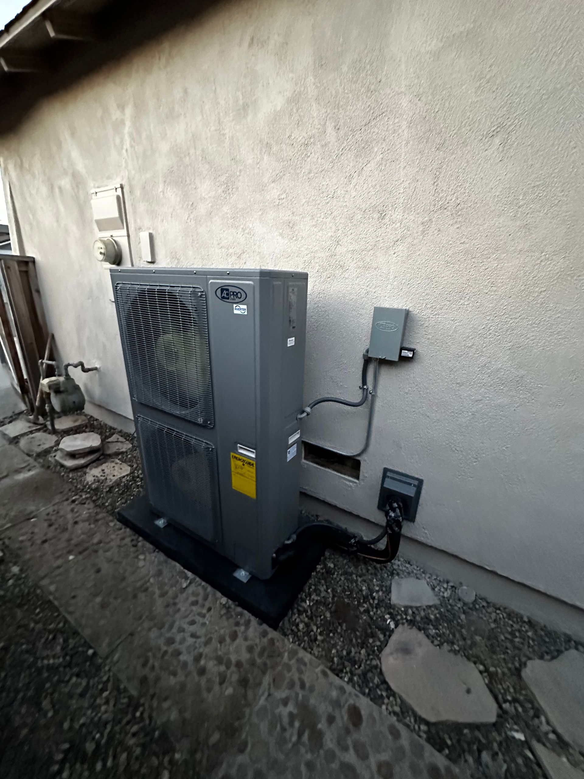 A large air conditioner is sitting on the side of a building.