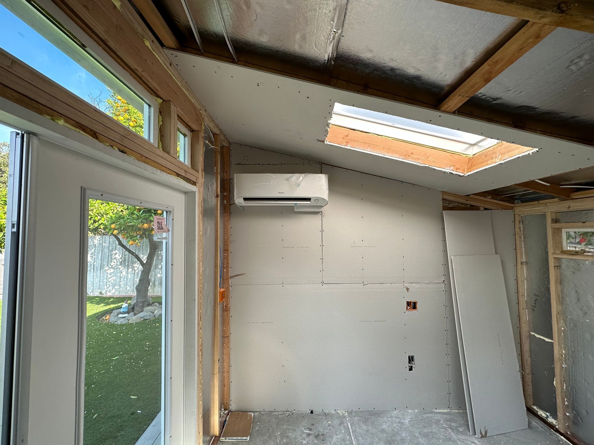 An empty room with a skylight and a window