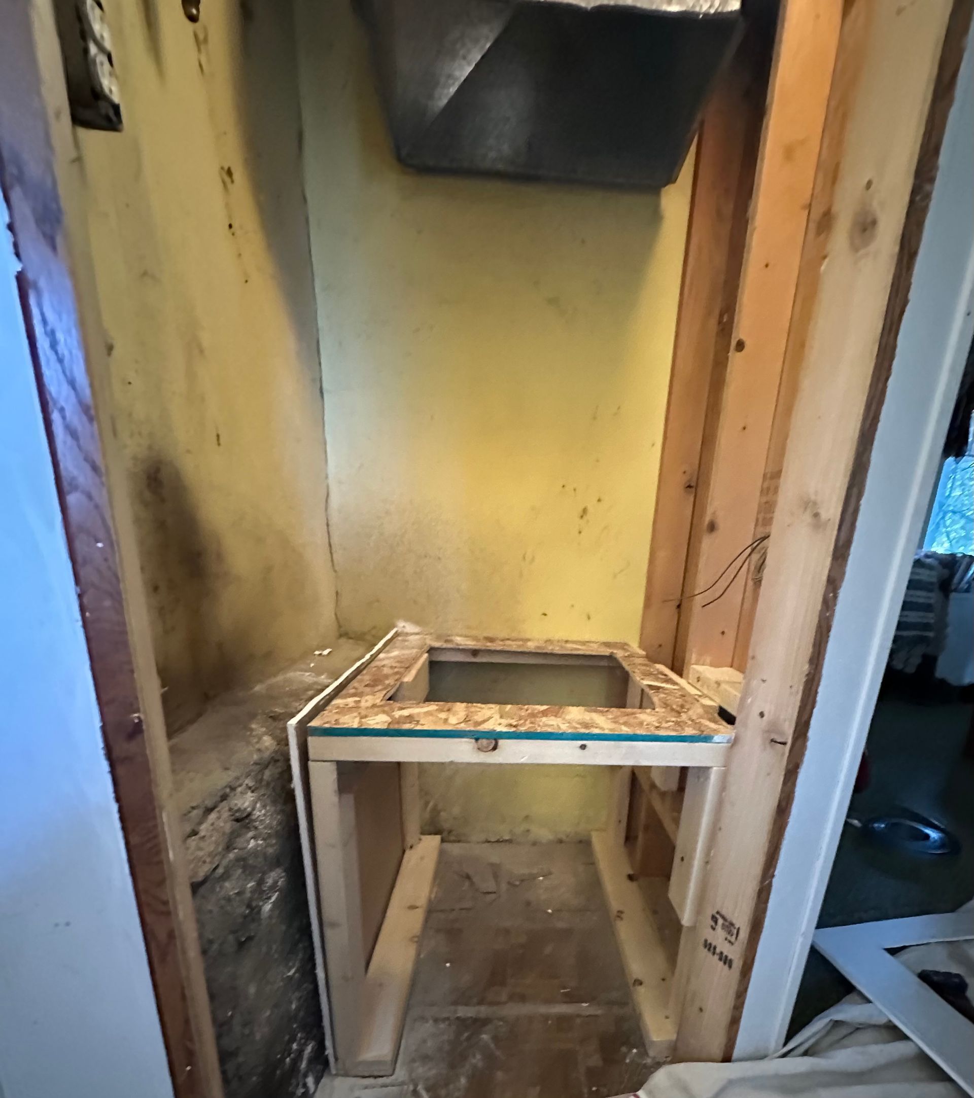 A small corner of a room with a sink in it