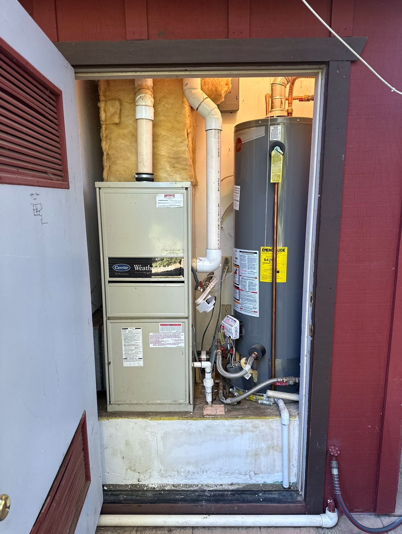 A room with a heater and a water heater in it