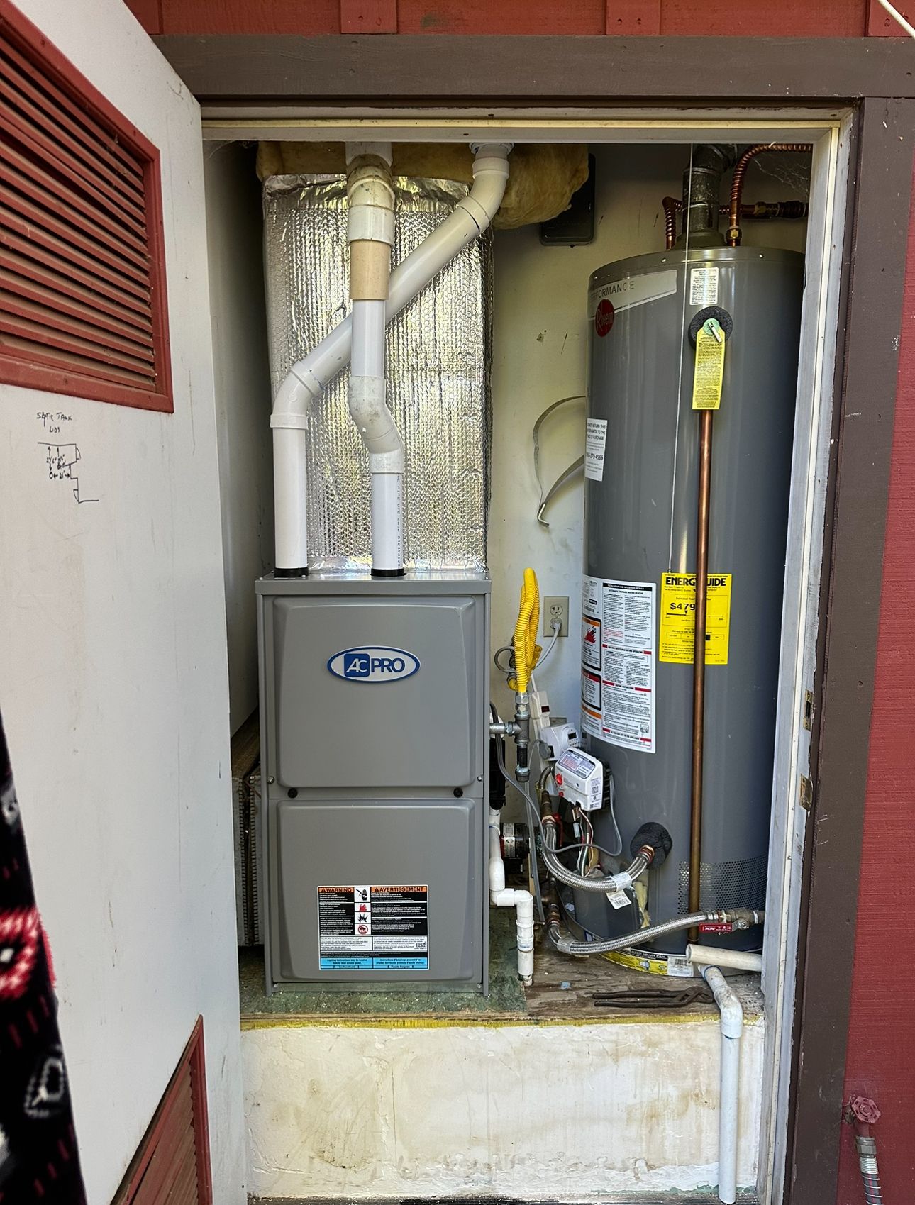 A room with a heater and a water heater in it.