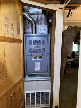 A furnace is stacked on top of each other in a closet.