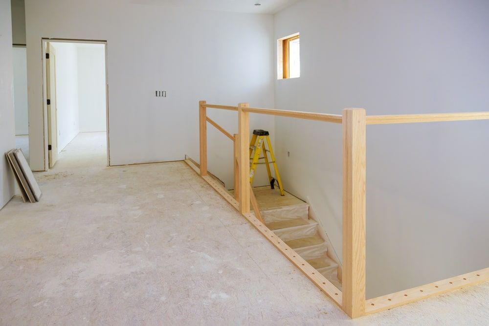 Empty Room With Stairs And A Wooden Railing — R3 Construction In O'Connor, ACT