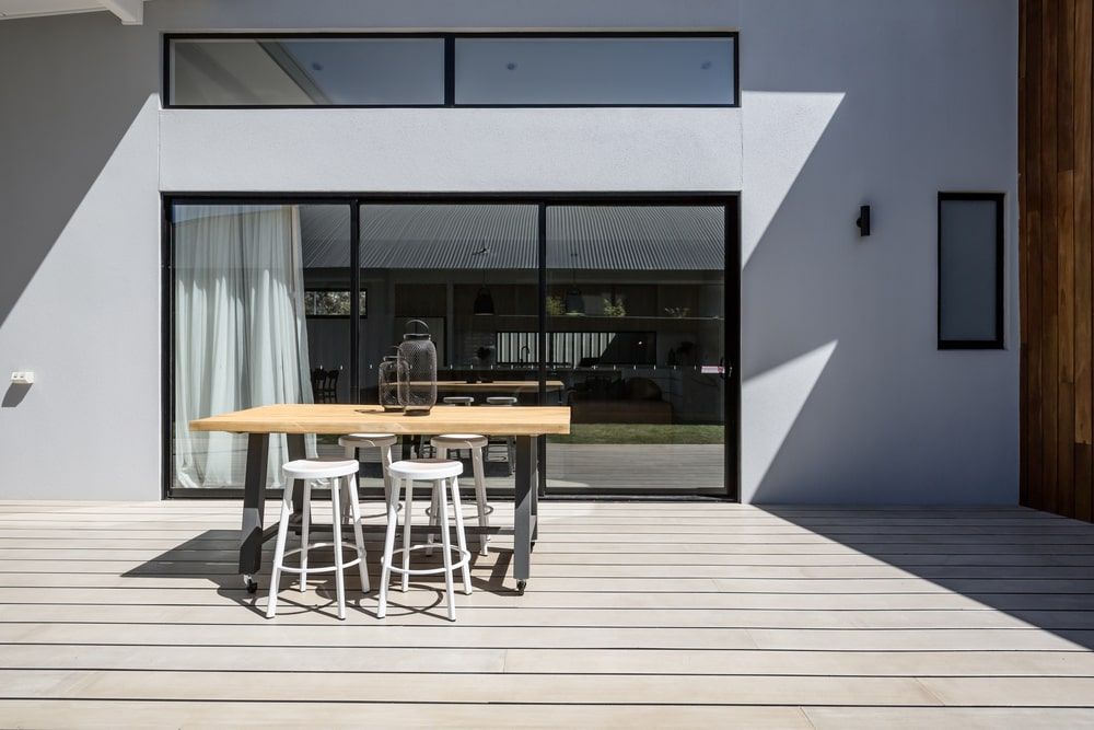 Table And Stools On A Deck In Front Of A House — R3 Construction In Queanbeyan, NSW