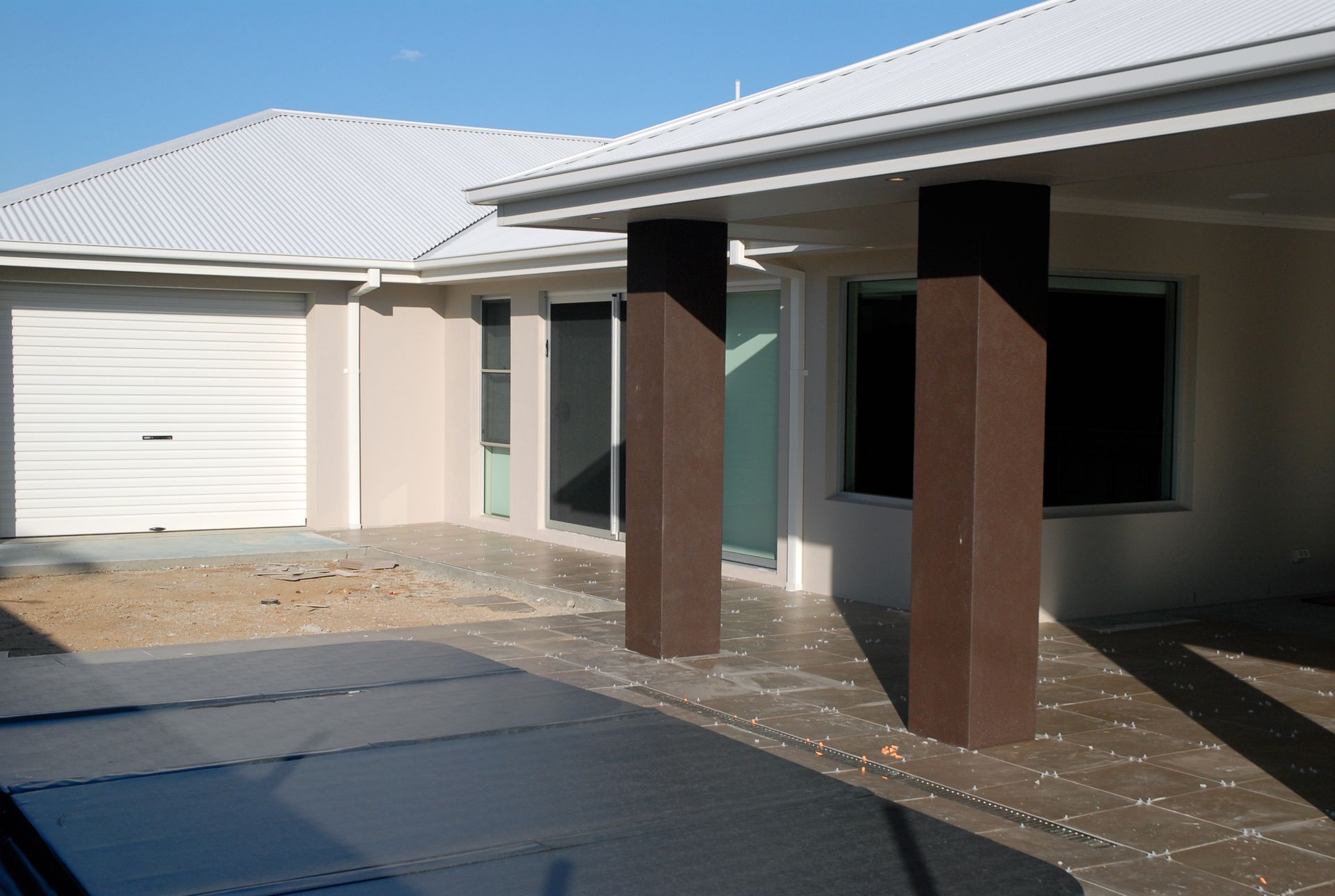 Man Standing On A Ladder In A Room Under Construction — R3 Construction In O'Connor, ACT