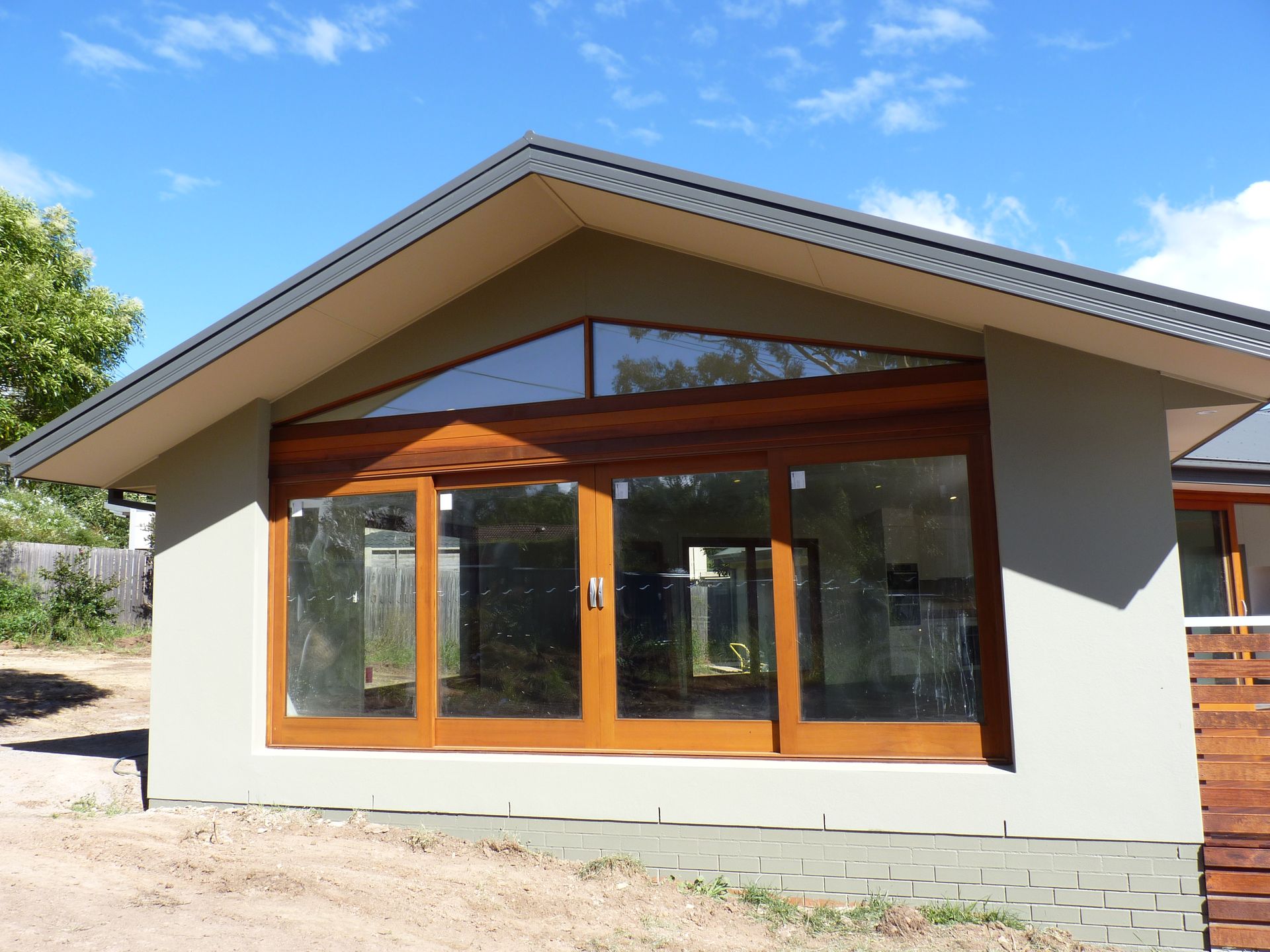 A house with a roof that has the letter n on it — R3 Construction In O'Connor, ACT