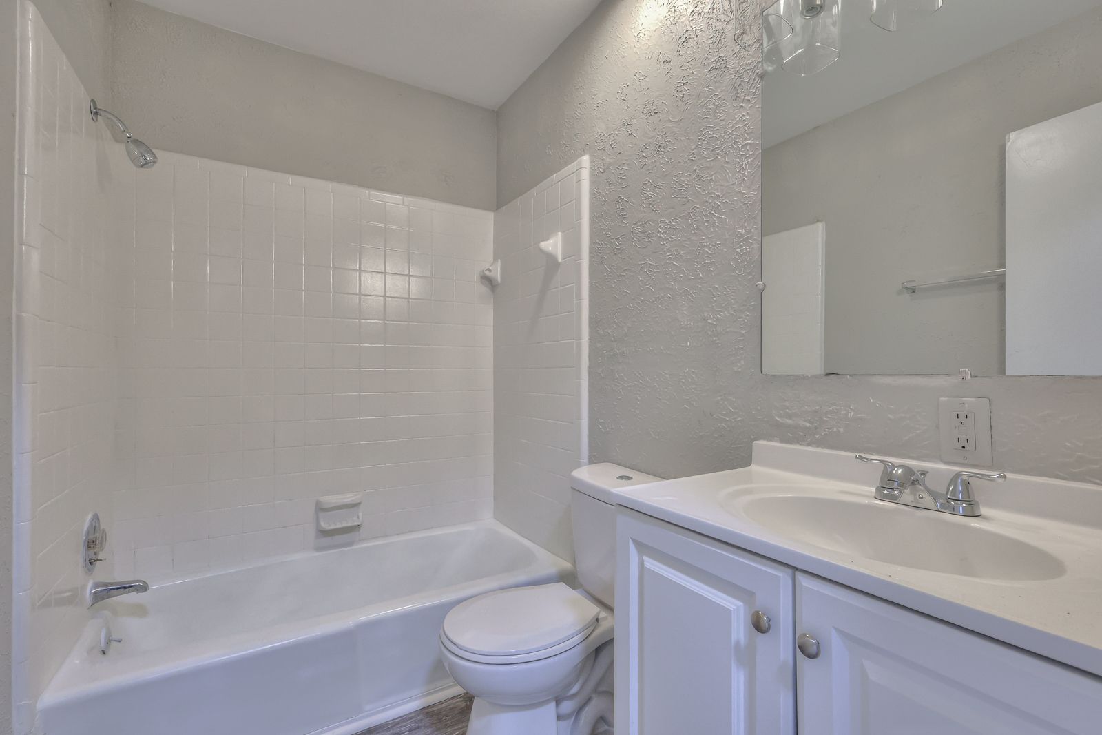 Photo of a bathroom with a bathtub/shower combination