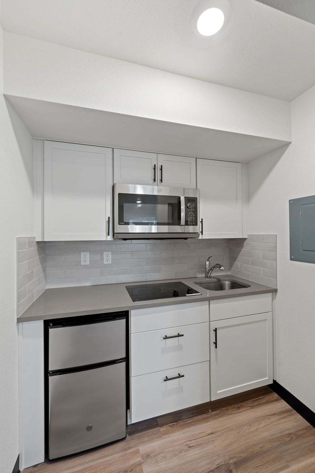 A kitchen with stainless steel appliances and white cabinets