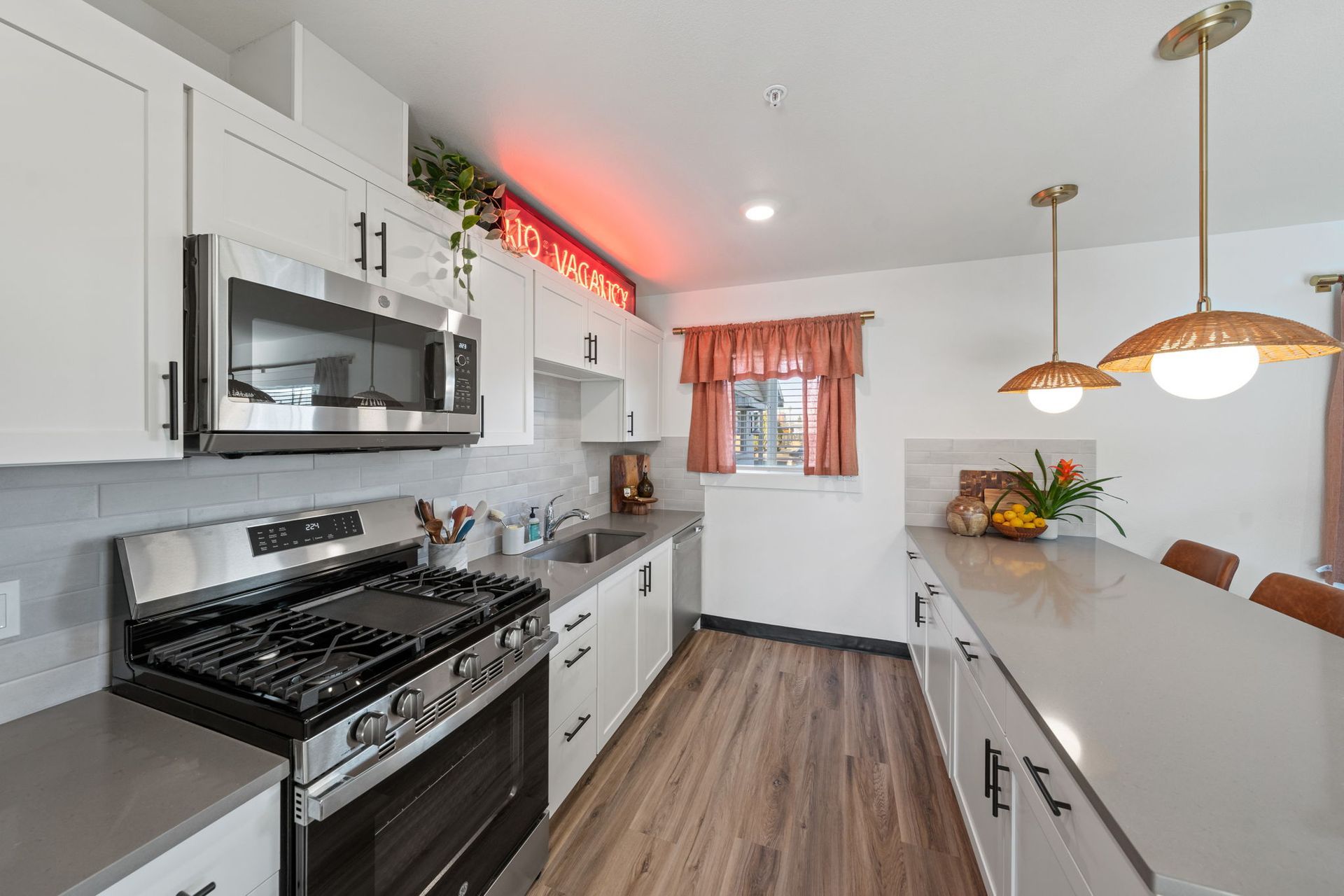 A kitchen with stainless steel appliances and white cabinets