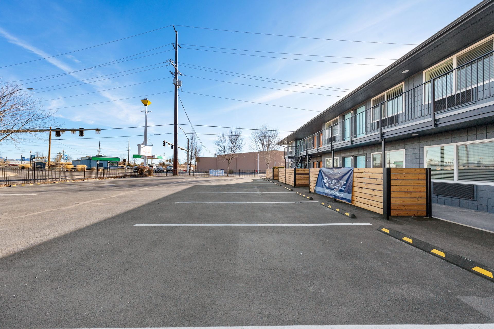 There is a parking lot in front of a building.