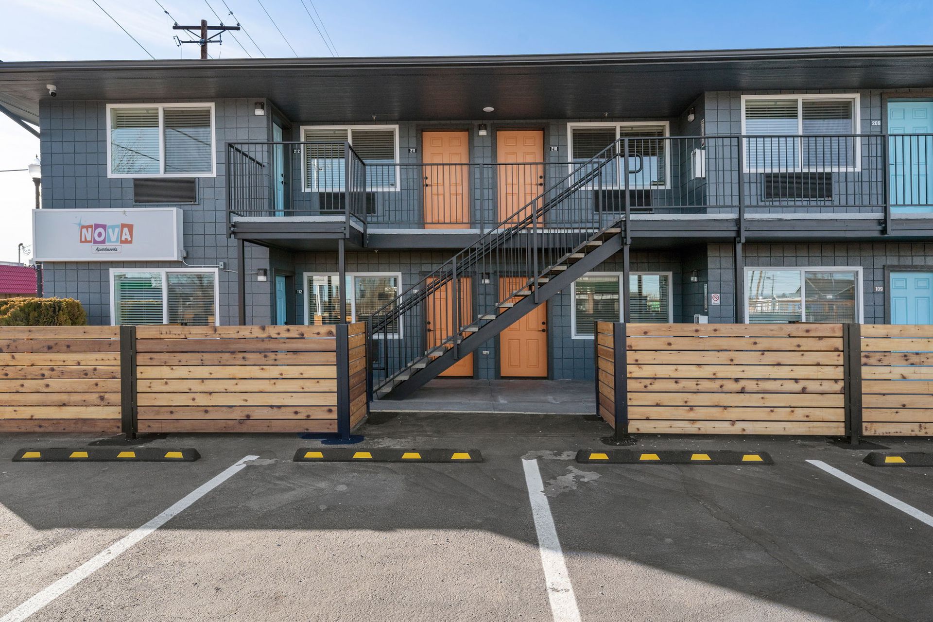 A building with stairs and a wooden fence in front of it