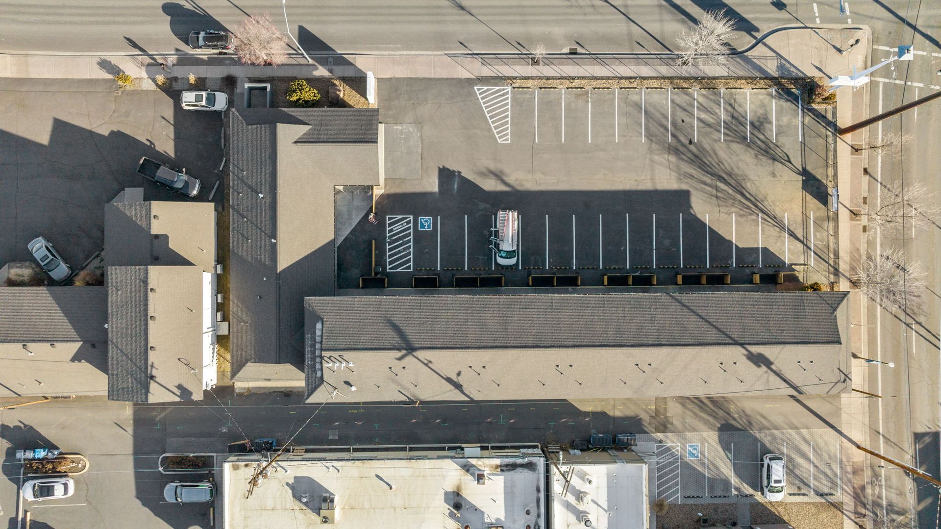 An aerial view of a parking lot with cars parked in it