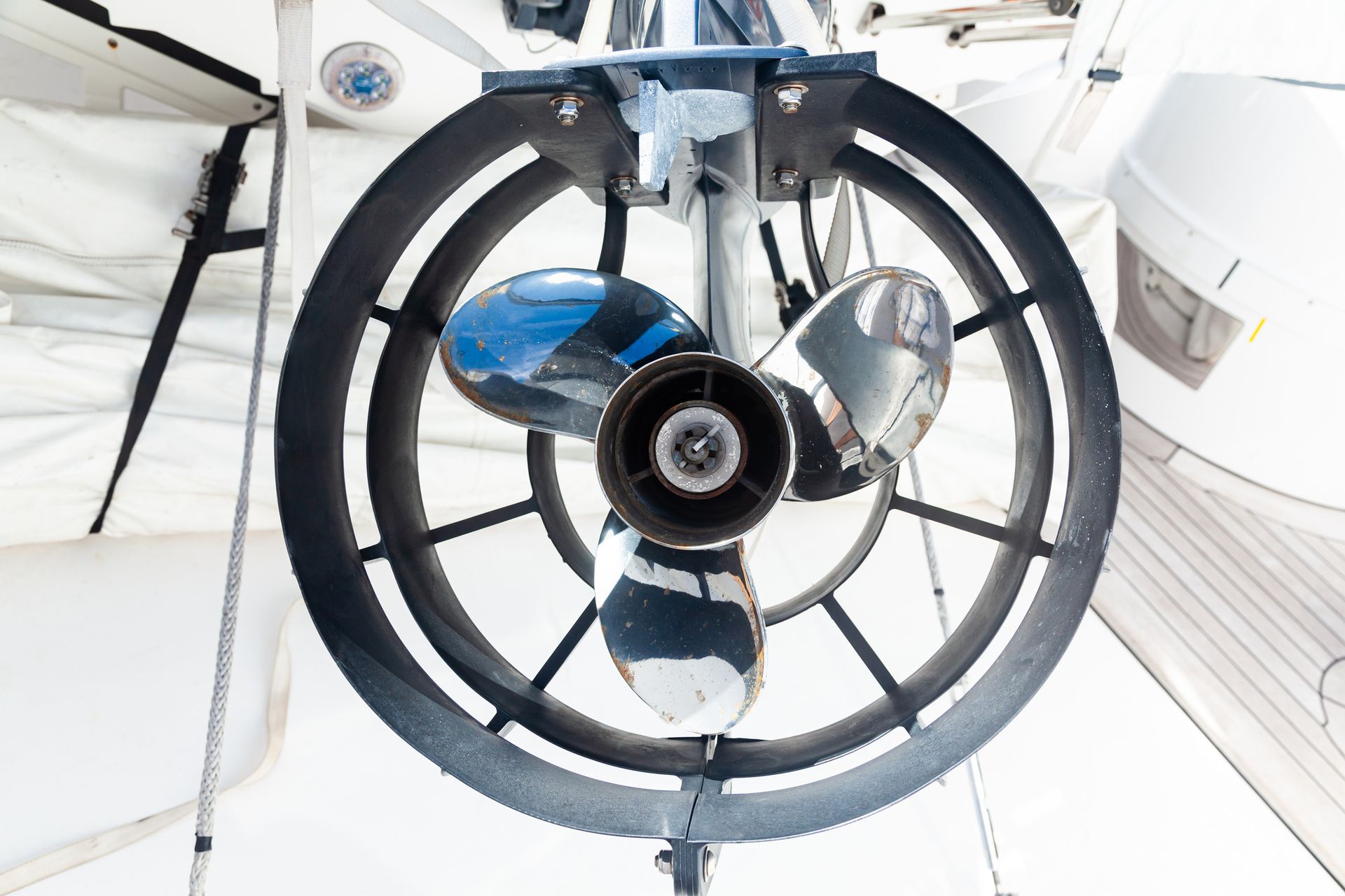 Close-up of a steel propeller guard protecting a boat motor, ensuring safety and durability.