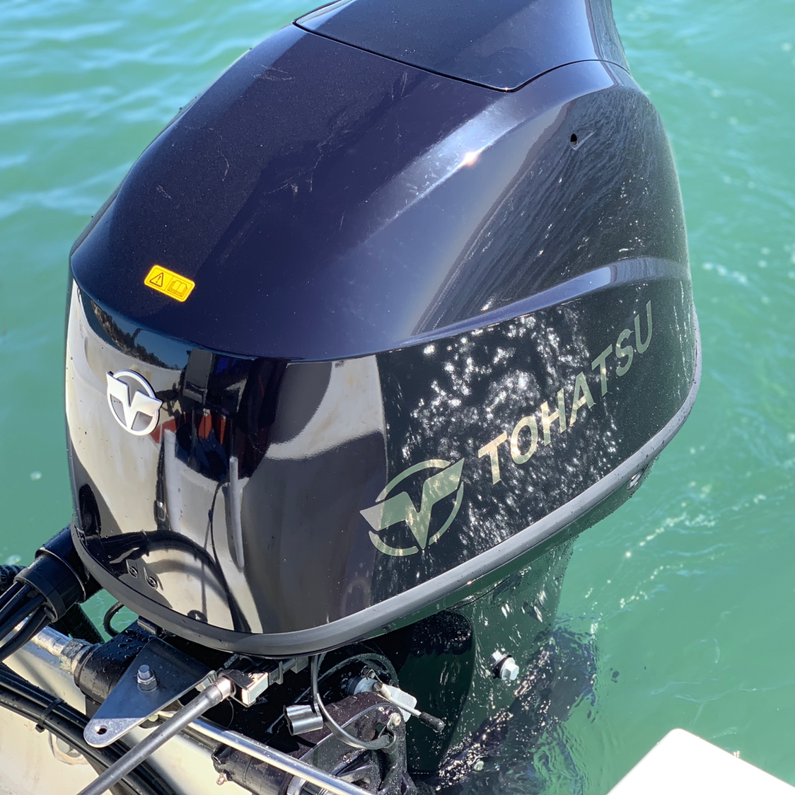 A Tohatsu outboard motor is sitting in the water