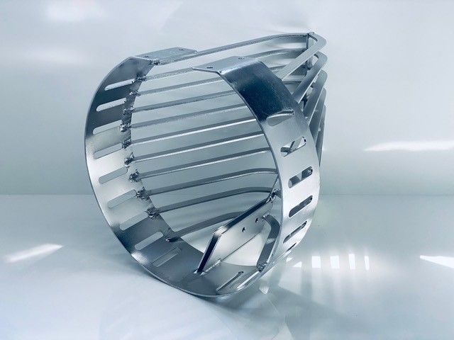 A stainless steel object is sitting on a white surface