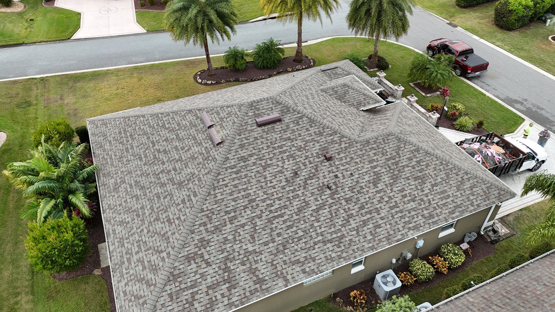 An aerial view of a house with a roof that is being repaired.