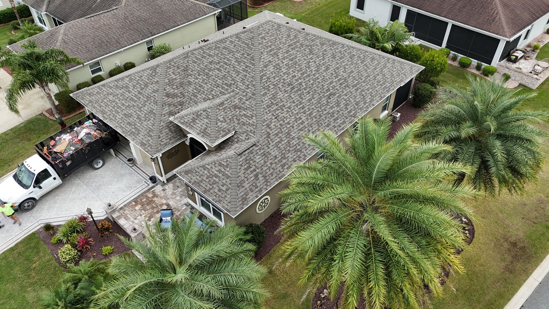 An aerial view of a house with a truck parked in front of it.