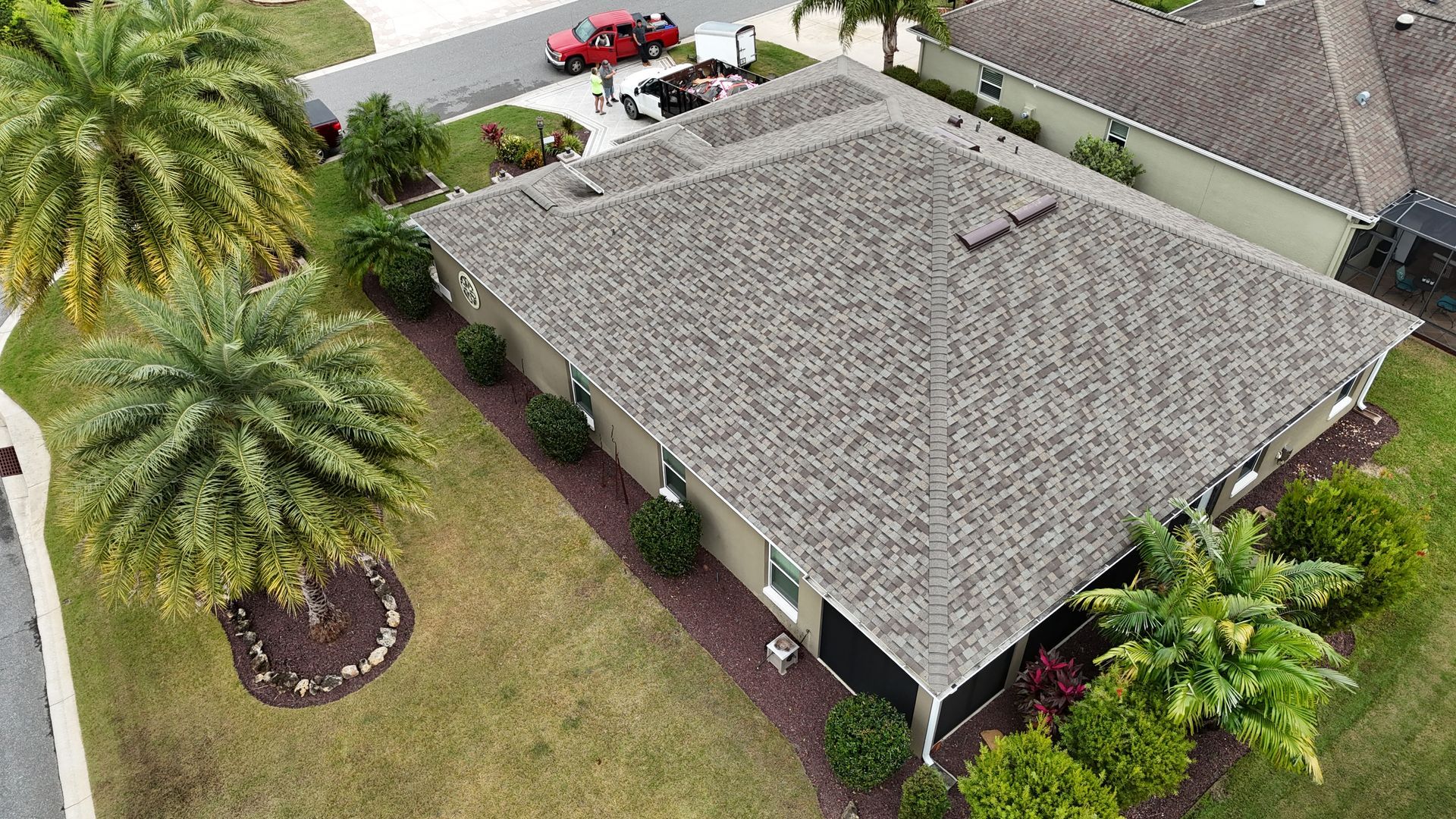 An aerial view of a house with a roof that is covered in shingles.