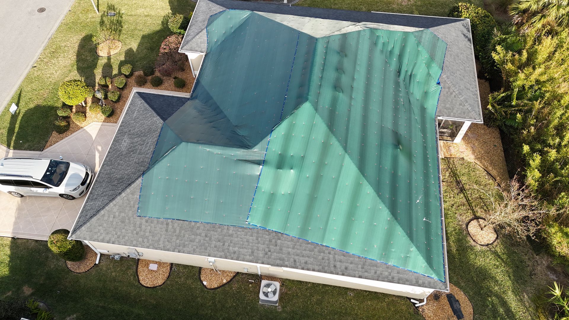 An aerial view of a house with a green roof.