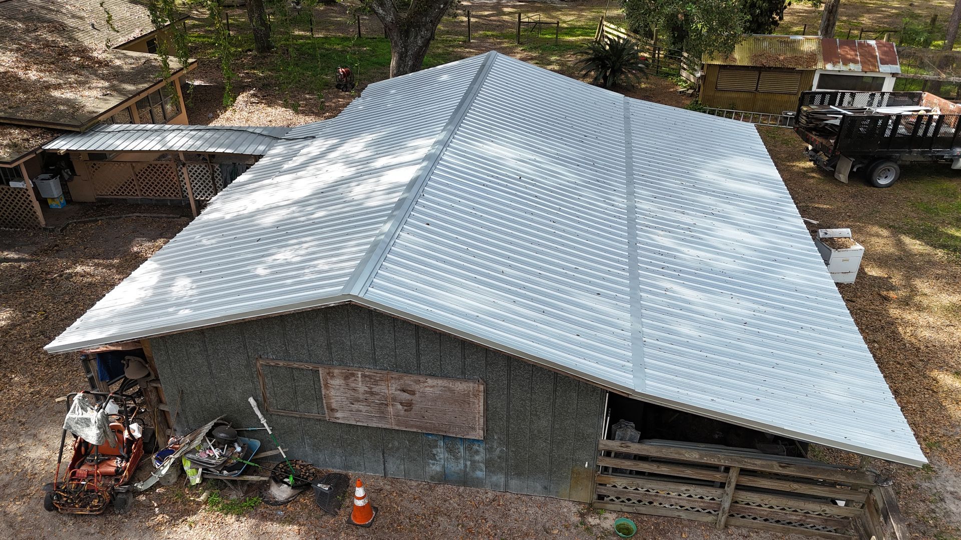 An aerial view of a house with a metal roof.