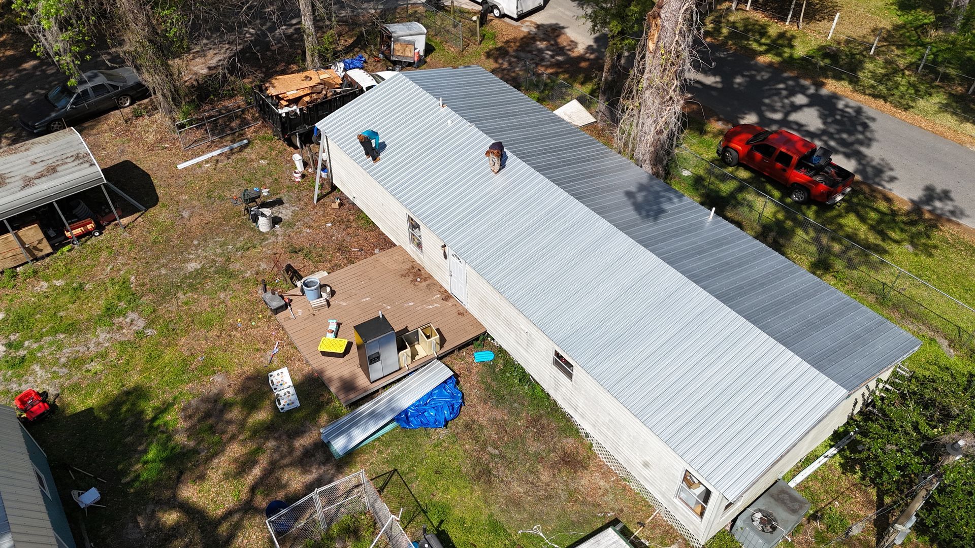 An aerial view of a house with a roof being installed.