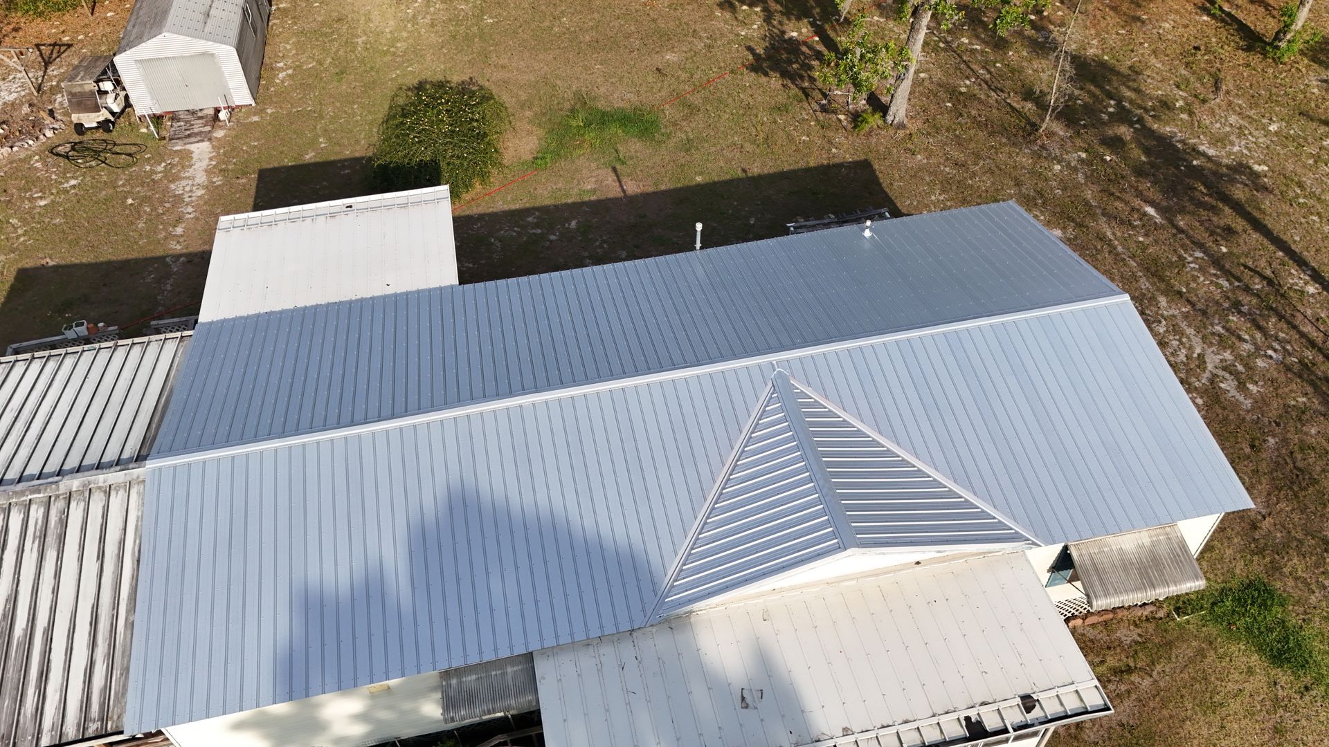 An aerial view of a house with a metal roof.