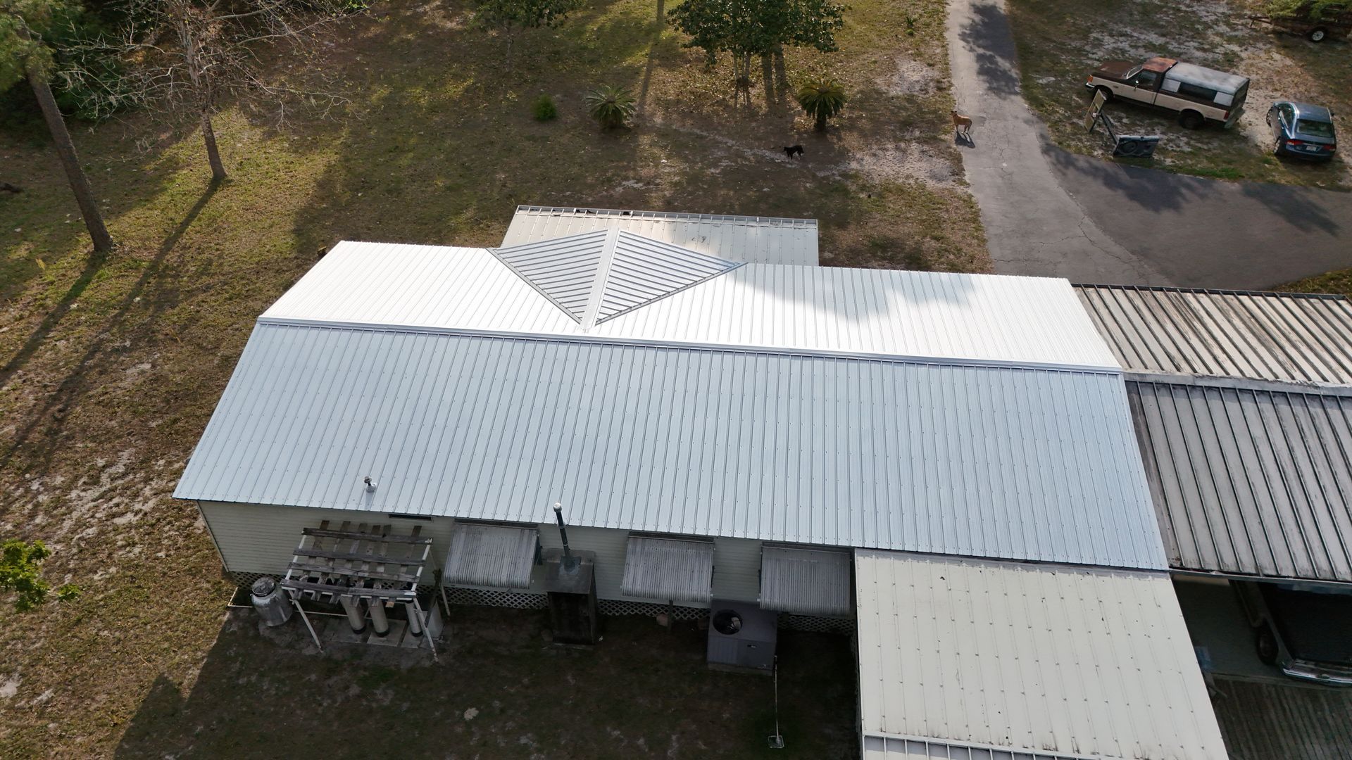 An aerial view of a house with a metal roof.
