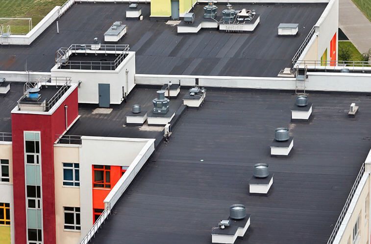 An aerial view of a building with a black roof