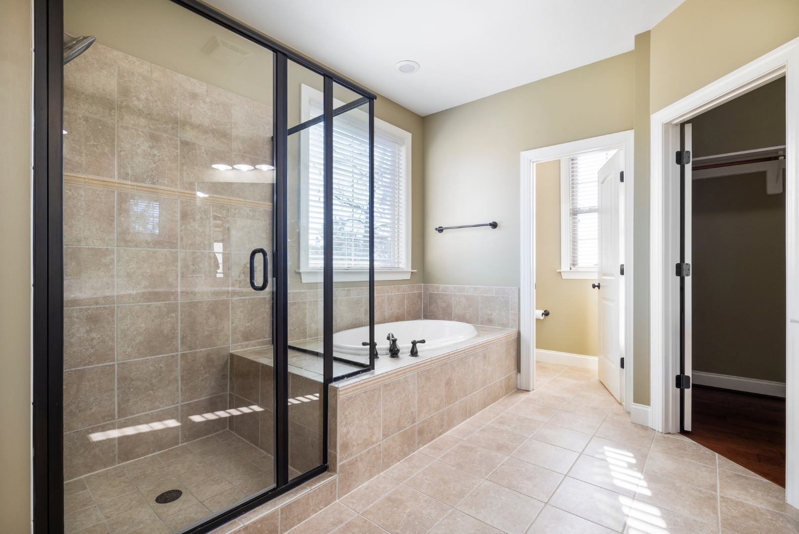 A bathroom with a tub and a walk in shower.