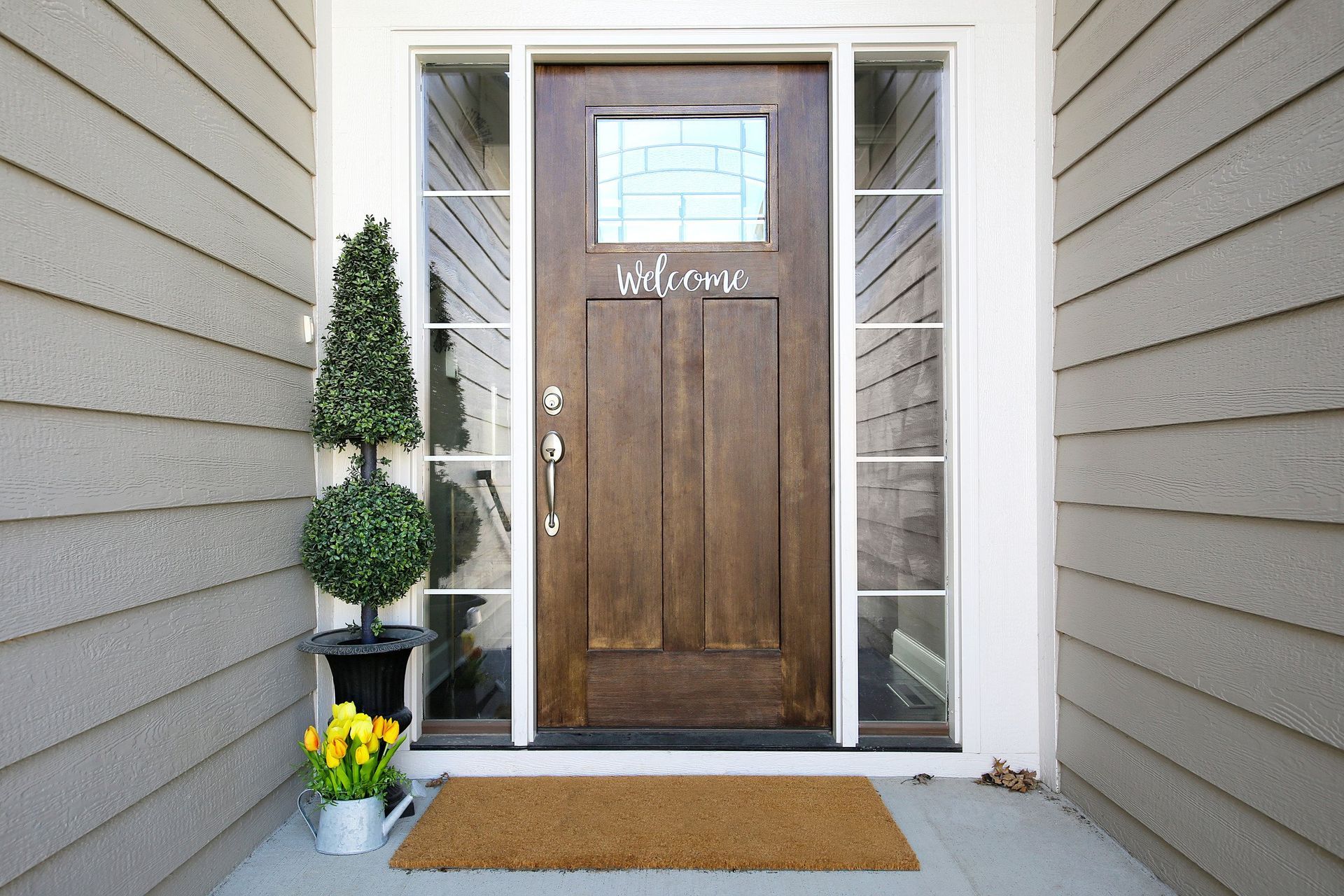 The front door of a house with a welcome sign on it
