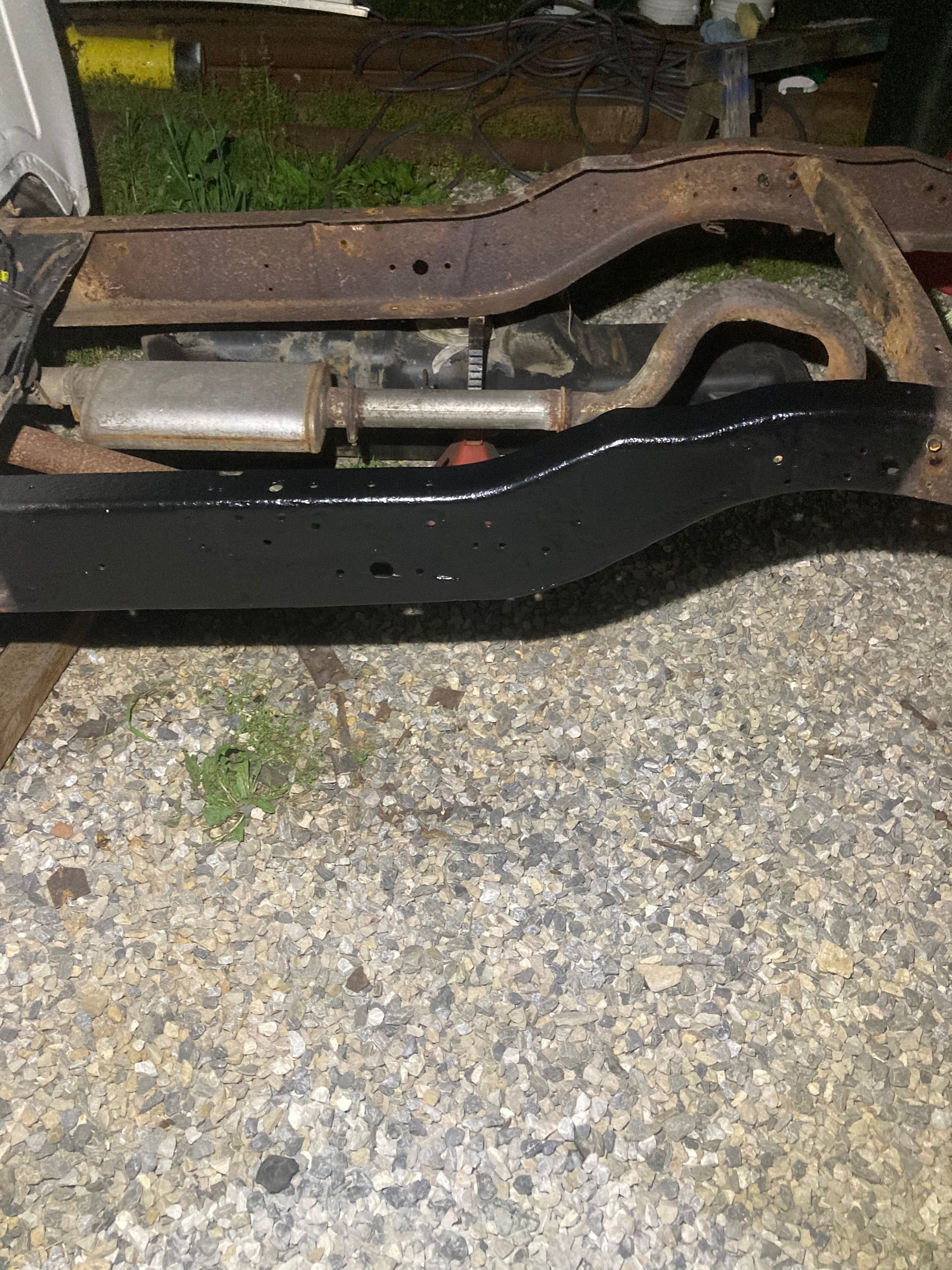 Construction site with steel framework and cranes under a blue sky.