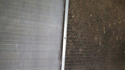 A close up of a dirty radiator and a clean radiator.