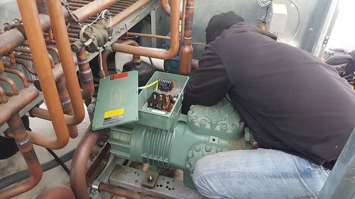 A man is working on a machine in a factory.