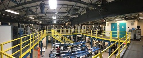An aerial view of a factory with a yellow railing.