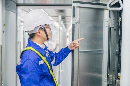 Worker inspecting commercial refrigeration equipment. Worker inspecting commercial refrigeration equipment.