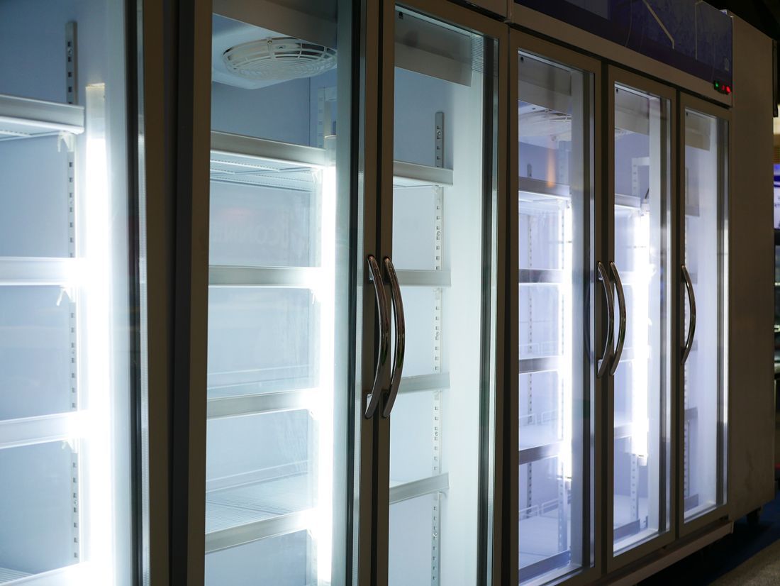 Commercial refrigeration system with multiple glass doors and adjustable shelves for product storage