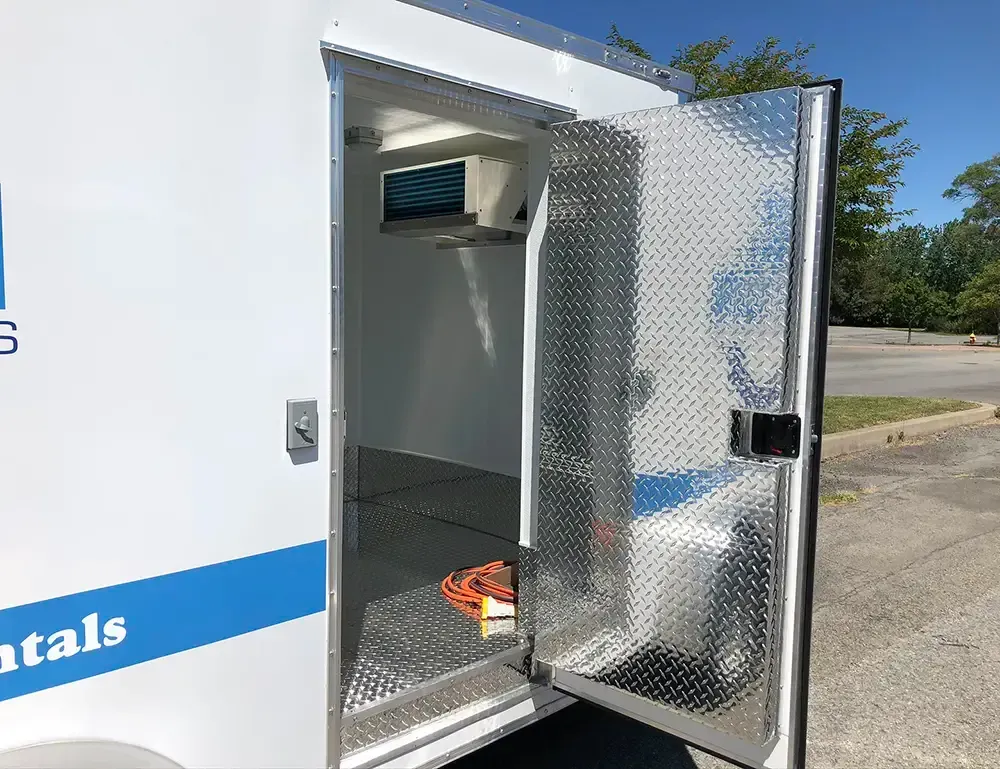 A white van with the door open is parked in a parking lot.