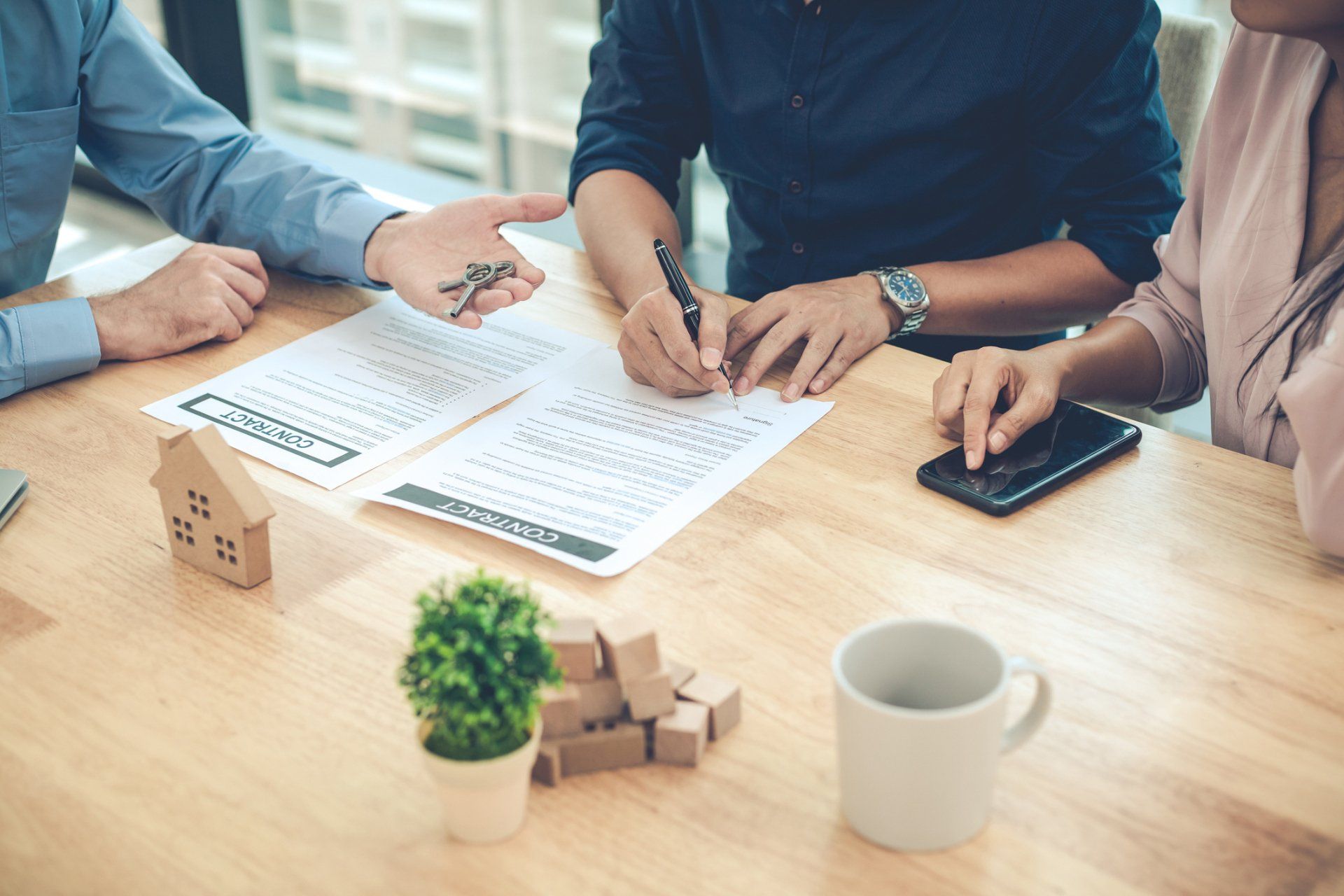 Man Signing a New Document — Lumberton, NC — Realty One Group Heritage