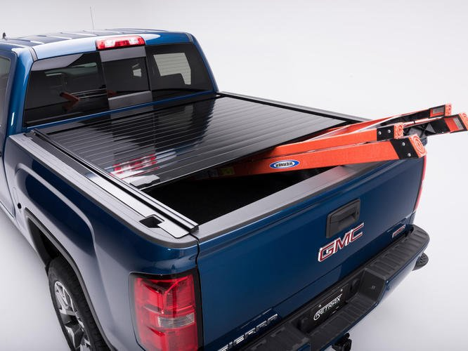 a blue gmc truck with a ladder in the bed