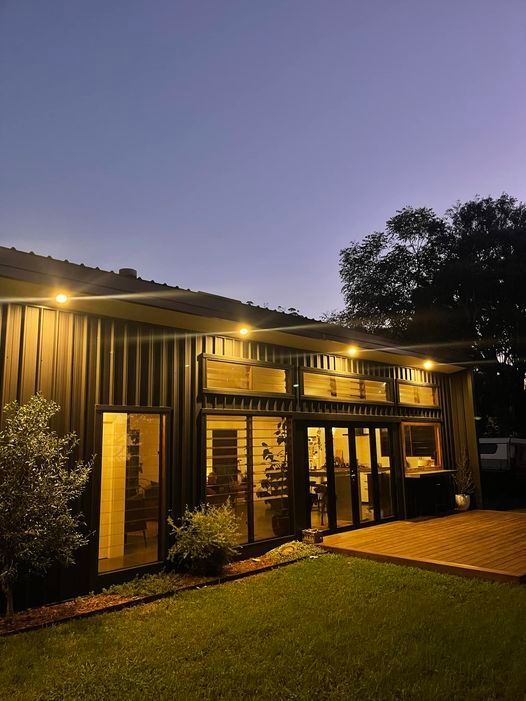 A Man Is Working On An Electrical Box With A Pair Of Pliers — EESI Electrical Contractors In Alstonville, NSW