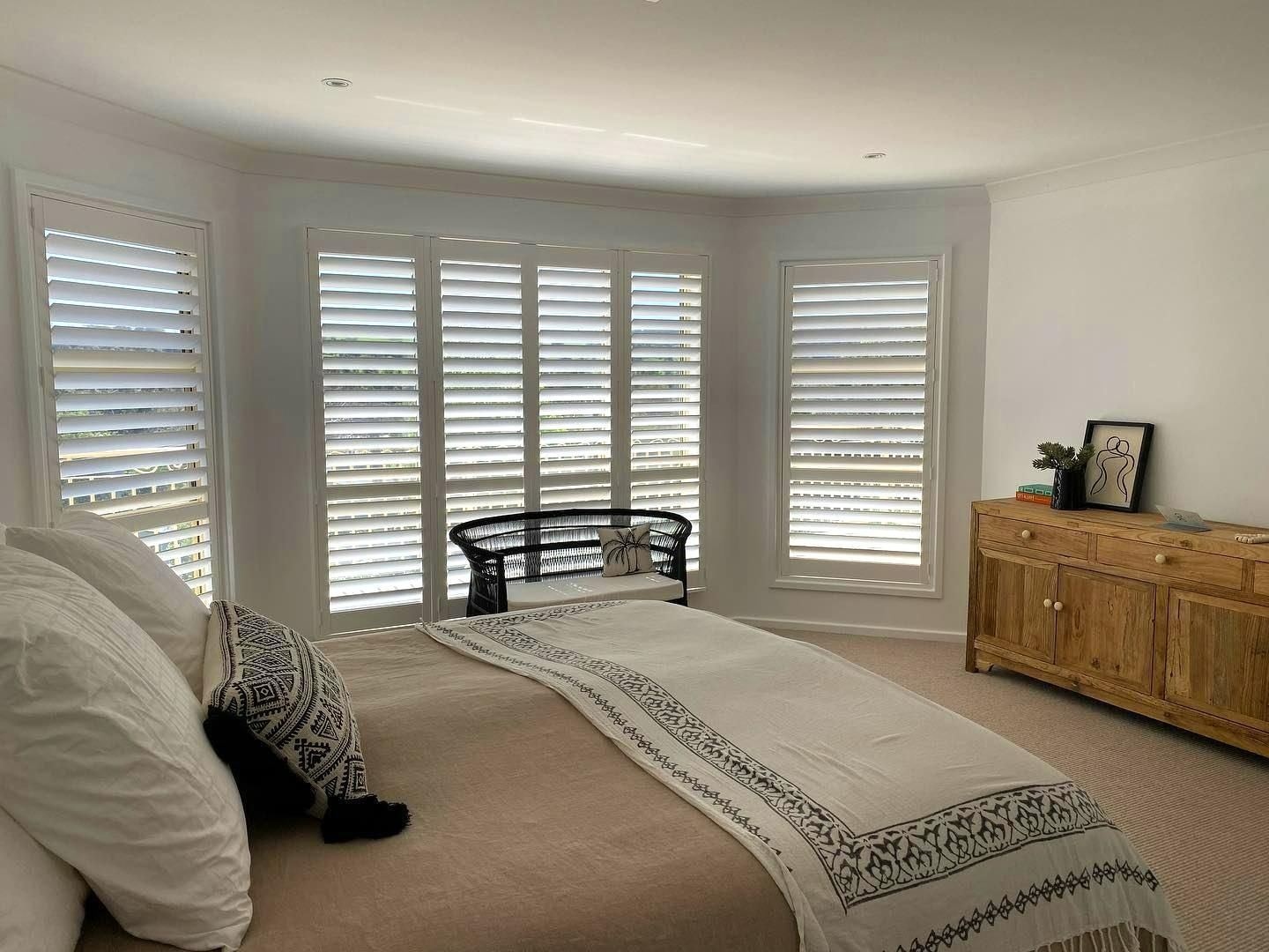 Bedroom With White Shutters And Wooden Dresser — JSF Interiors Goulburn in Goulburn, NSW