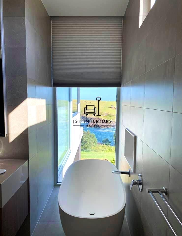 Bathroom With White Tub And Large Window View — JSF Interiors Goulburn in Gerringong, NSW