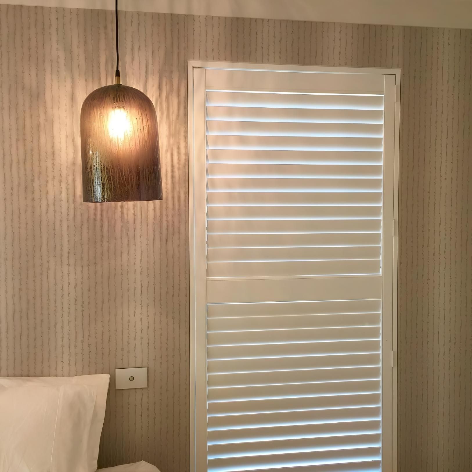 Pendant Lamp Over Bed Next To Shuttered Window — JSF Interiors Goulburn in Goulburn, NSW
