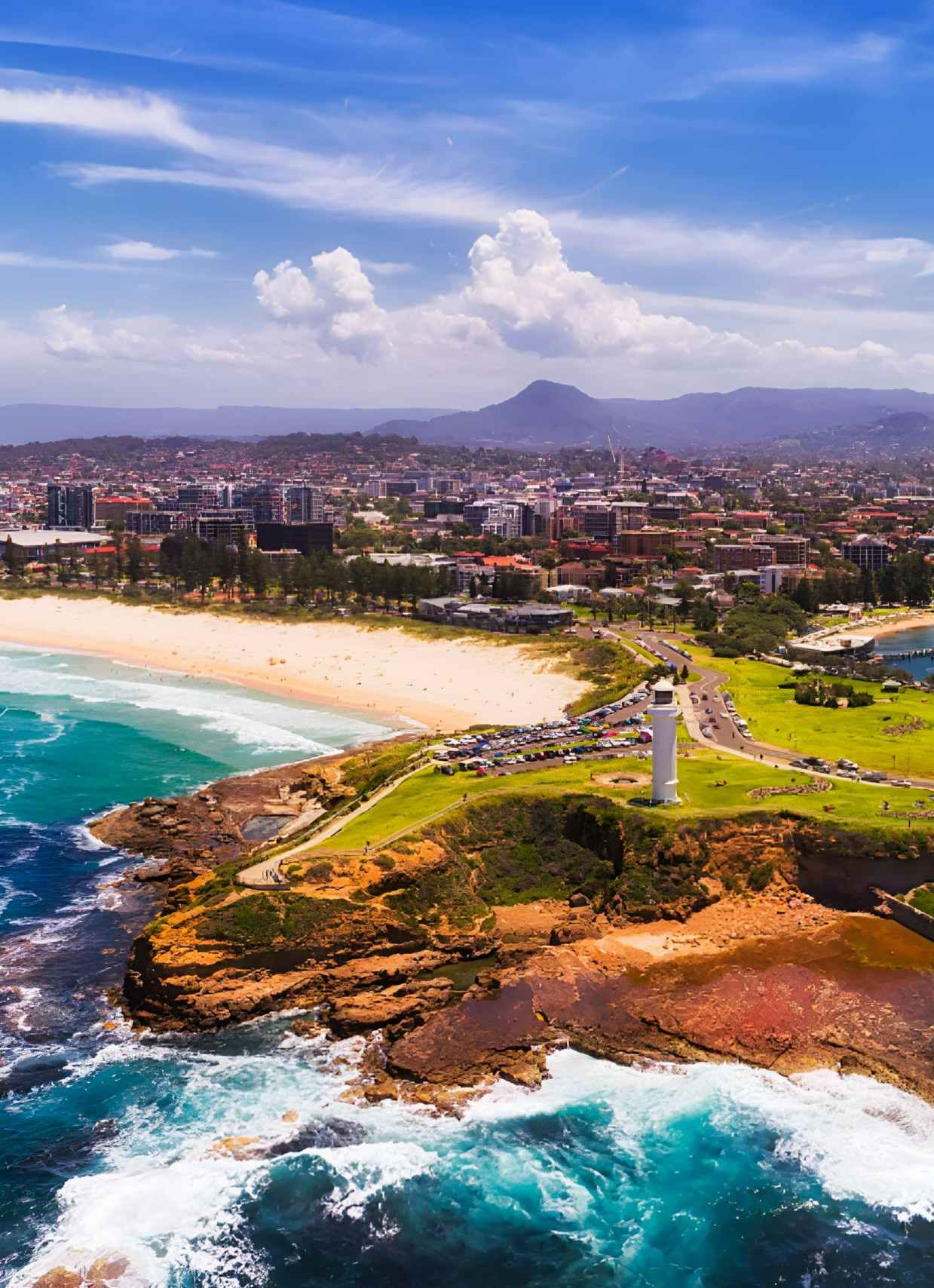 Coastal City With Beach Lighthouse Harbor And Mountains — JSF Interiors Goulburn in Kiama, NSW