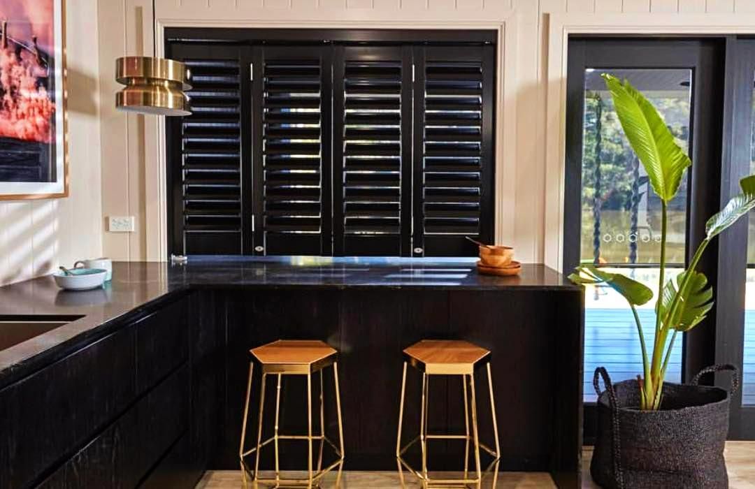 Black Shutters Over Kitchen Window With Gold Bar Stools — JSF Interiors Goulburn in Moss Vale, NSW