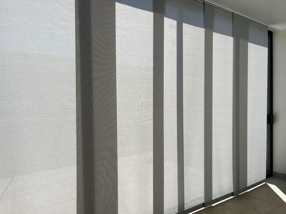 Gray Panel Blinds Filtering Sunlight Indoors — JSF Interiors Goulburn in Goulburn, NSW