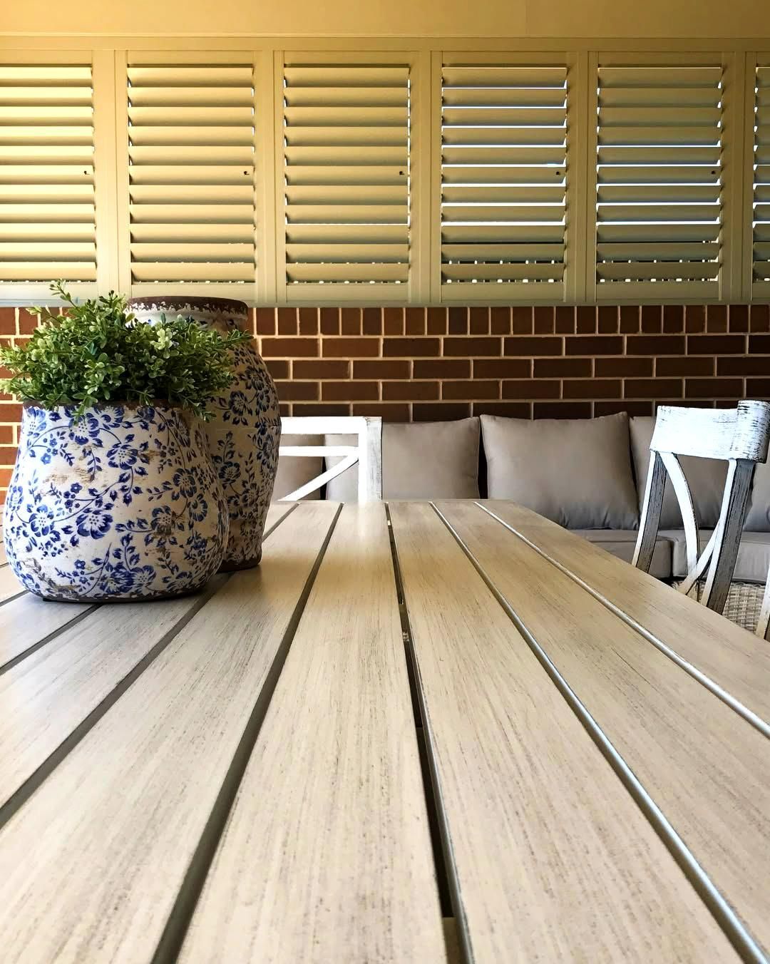 Outdoor Table With Plant and Shutters — JSF Interiors Goulburn in Shellharbour, NSW