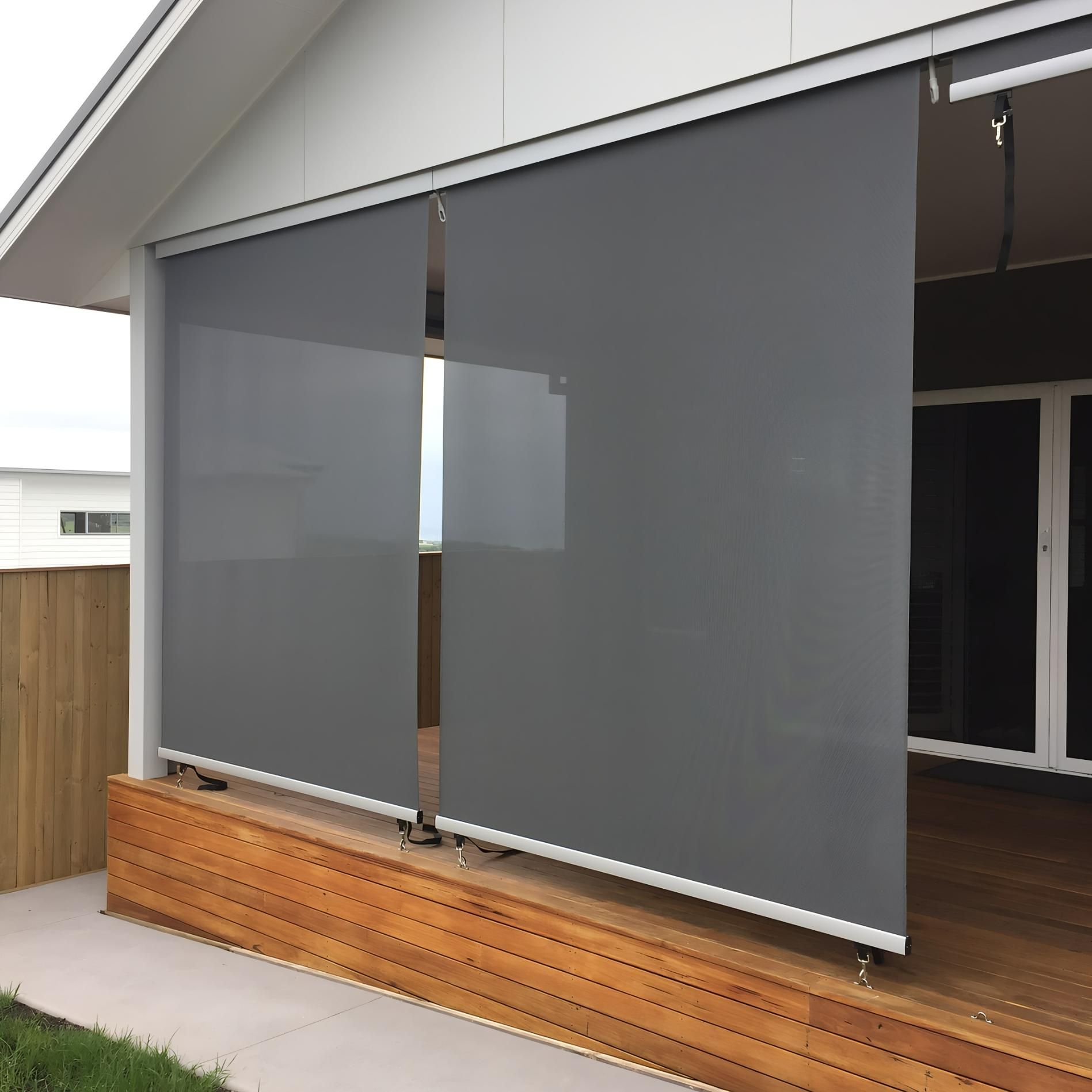 Gray Outdoor Roller Blinds On Wooden Deck — JSF Interiors Goulburn in Goulburn, NSW