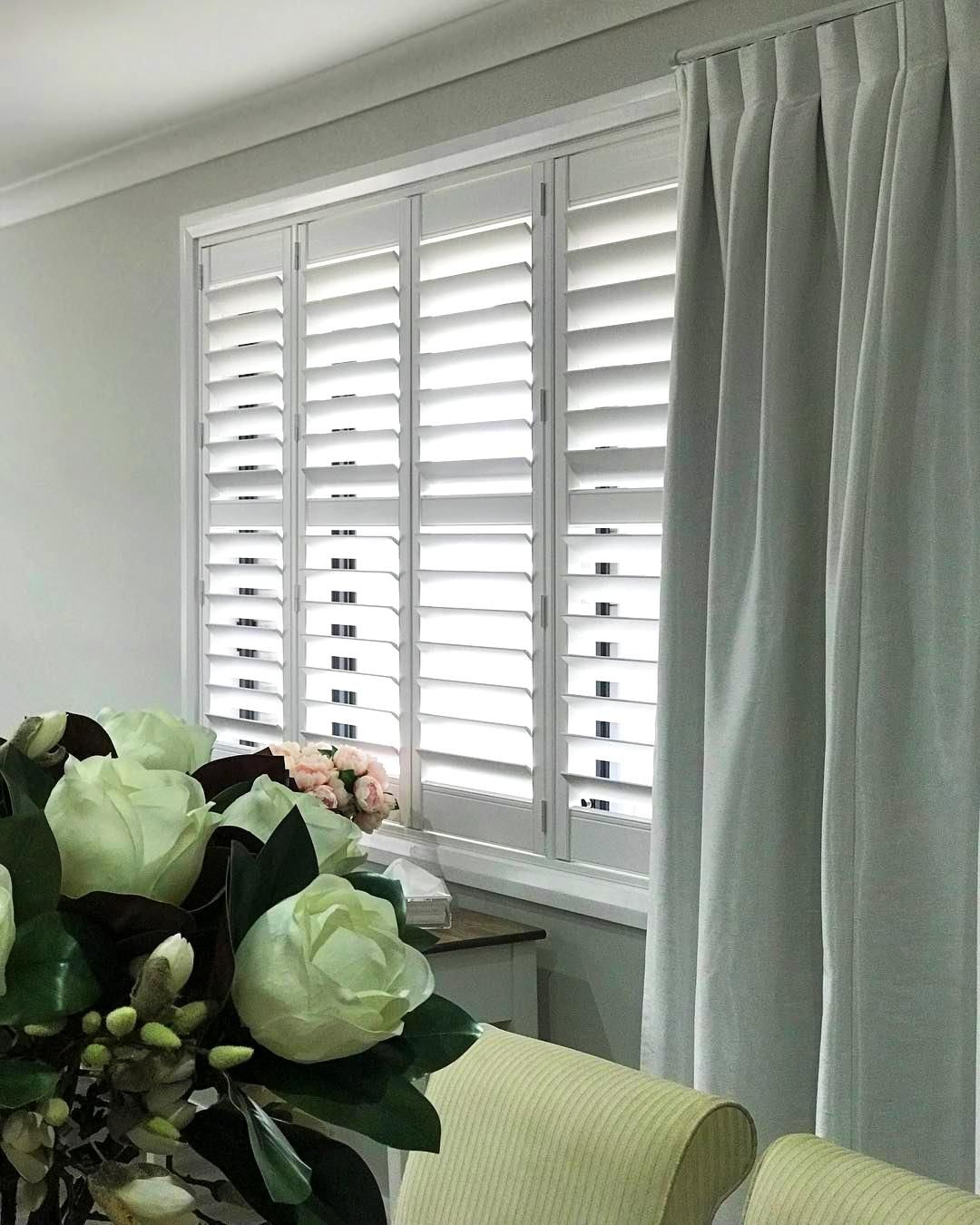 Window With White Shutters, Gray Curtains, And Flower Bouquet — JSF Interiors Goulburn in Gerringong, NSW