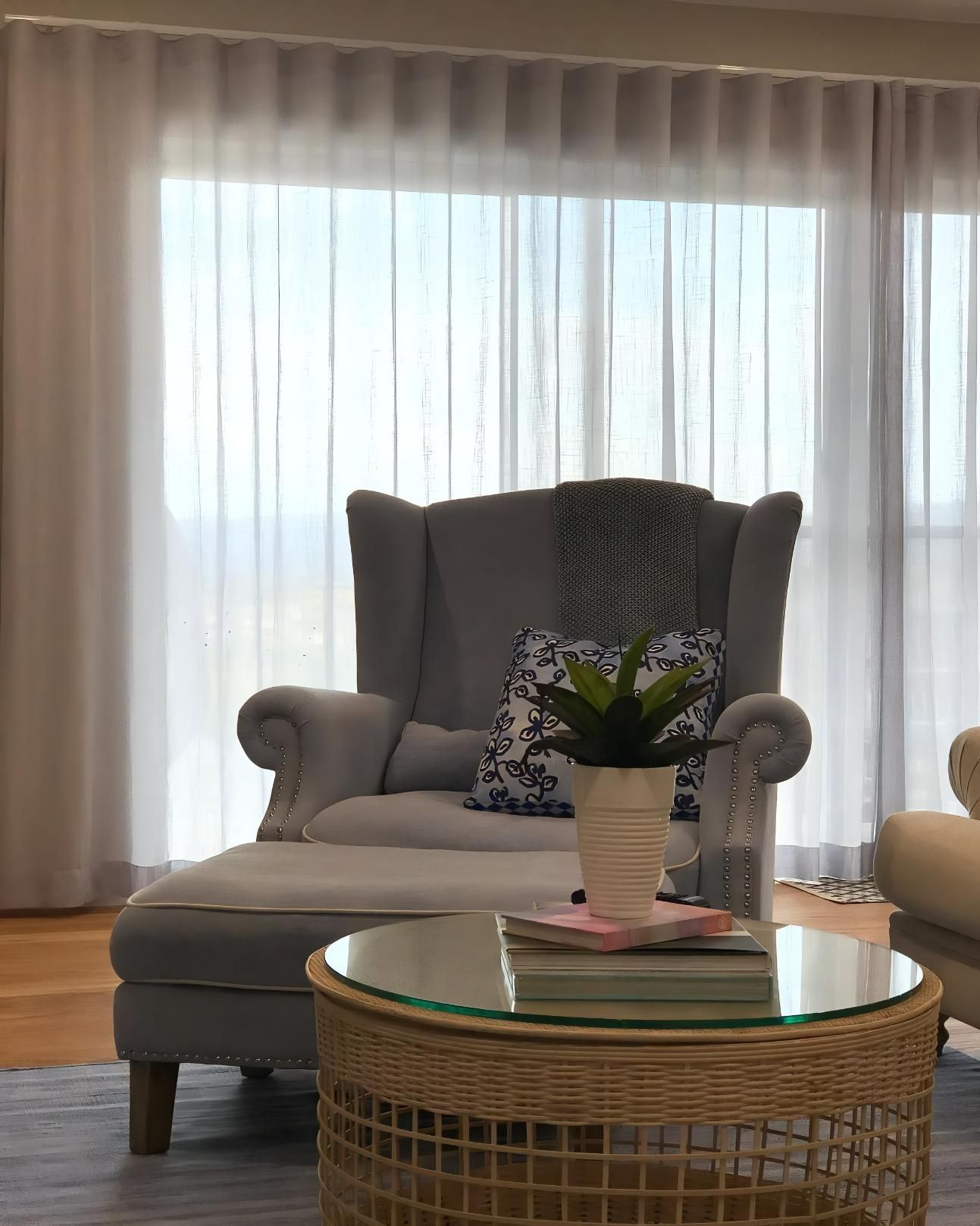 Cozy Living Room With Gray Armchair And Glass Table — JSF Interiors Goulburn in Goulburn, NSW